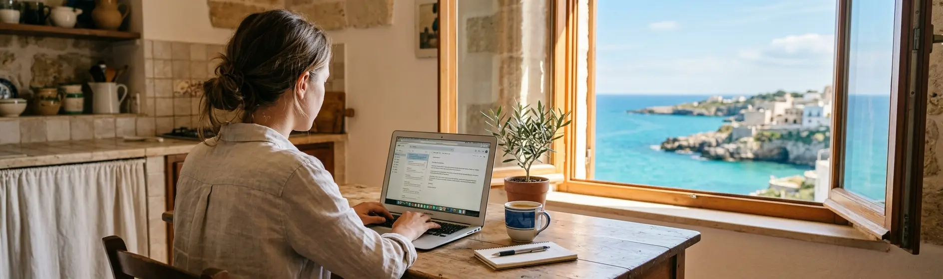 Person checking currency exchange rates on a laptop with a sea view